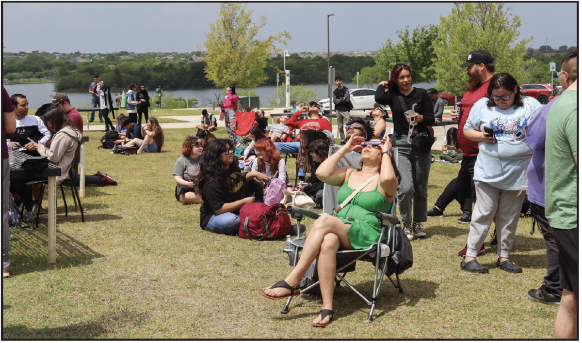 NW campus members sat in front of NW05 observing the eclipse.